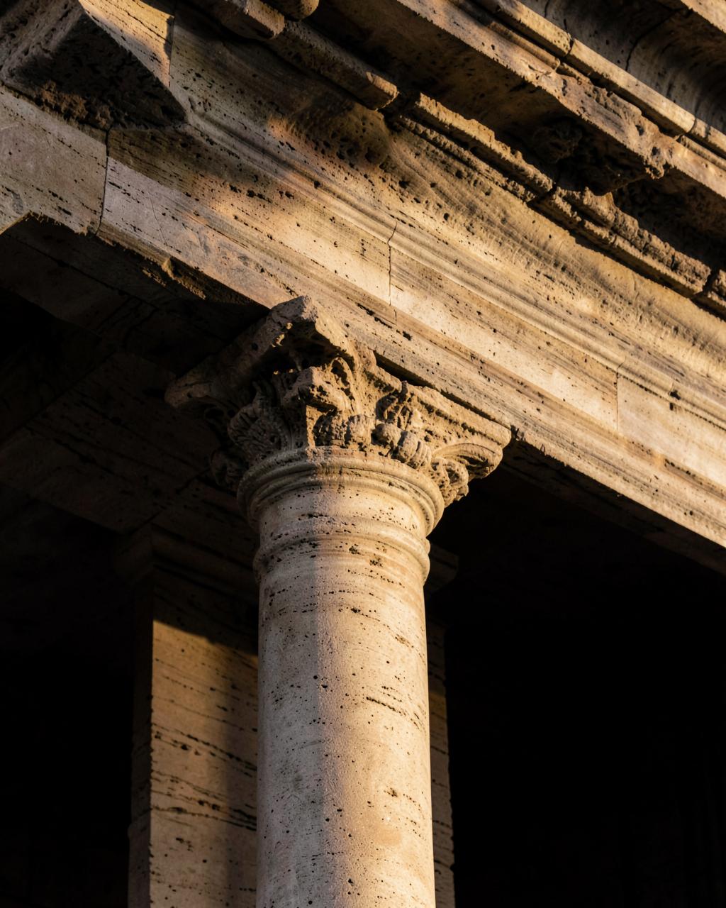 Detail of travertine columns in warm Roman light